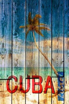 the word cuba painted on wooden planks with a palm tree