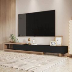 a large flat screen tv mounted to the side of a wall in a living room