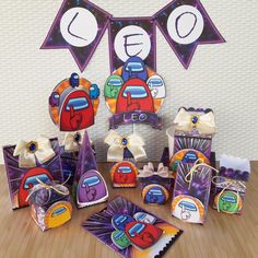 an assortment of items displayed on a wooden table with paper decorations and bunting flags