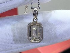 "18k Emerald Cut Moissanite Necklace | 1-3ct Colorless Moissanite Pendant | Elegant Diamond Pendant | White/Rose/Yellow Gold Pendant Necklace Dainty Emerald Cut Moissanite Pendant Collarbone Necklace. Available in 18k Gold and 925 Sterling Silver. The chain is 16\" long. Please message me if you need a longer one. 》Moissanite Stone Details《 Gemstone: Moissanite Loose Stone Shape: Emerald Color: D White/Colorless Cut Grade: Excellent Polish: Excellent Symmetry: Very Good Clarity: VVS 1 Hardness: Octagon Brilliant Cut Diamond Necklace Gift, Brilliant Cut Diamond Octagon Necklace Gift, Octagon Brilliant Cut Diamond Necklace For Gift, Brilliant Cut Octagon Diamond Necklace For Gift, White Diamond Solitaire Necklace With Gemstone, White Gold Octagon Diamond Necklace Gift, White Gold Octagon Diamond Necklace For Gift, Octagon White Gold Diamond Necklace Gift, White Emerald-cut Solitaire Necklace As Gift