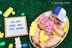 a baby in a bucket with easter decorations around it and a sign that says i'm just here for the chicks