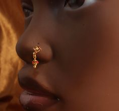 a close up of a child's nose and nose piercing