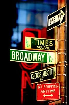 several street signs are posted on a pole