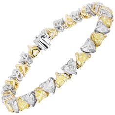 Gorgeous and Unique Yellow and White Diamond Bracelet. 16 Heart Shaped Yellow Diamonds weighing 8.45 Carats. 16 Heart Shaped Diamonds weighing 8.10 Carats. Set in Platinum and 18 Karat Yellow Gold. Measures 6.75 inches. Luxury Heart Cut Diamond Bracelet With Diamond Accents, Luxury Heart Bracelet With Brilliant Cut For Anniversary, Luxury Heart Cut Diamond Bracelet For Anniversary, Luxury White Gold Heart Bracelet For Anniversary, Luxury Yellow Gold Heart Cut Bracelet, Luxury White Gold Heart-shaped Diamond Bracelet, Fine Jewelry Yellow Bracelets For Anniversary, Yellow Fine Jewelry Bracelets For Anniversary, Luxury Heart Cut Tennis Bracelet