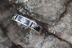 A beautifully crafted sterling silver piece inlayed with Nevada Turquoise, Coral, Black Onyx and Shell centered on a sterling silver cuff. A great addition to any days wear. Artist: C. Dishta. Zuni, NM. Handmade in the USA. Vintage. Southwestern Silver Cuff Bracelet With Inlay, Southwestern Inlay Cuff Bracelet Gift, Artisan Silver Cuff Bracelet With Inlay, Southwestern Sterling Silver Inlay Bracelet Gift, Artisan Sterling Silver Bracelet With Inlay, Unique Sterling Silver Cuff Bracelet With Inlay, Sterling Silver Cuff, Silver Pieces, Silver Cuff