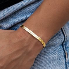 Introducing the Herringbone Bracelet- 4mm in 18k Yellow Gold! This sleek bracelet is sure to become your next staple piece adding just enough style and simplicity to any look. Featuring a classic herringbone pattern, this piece reflects light from every angle and complete with our signature 'G' clasp. Rock it solo, or pair it with the Herringbone Necklace in Yellow Gold for a matching set! This product is guaranteed for life – GLD will repair or replace the item should you experience any defects Minimalist Yellow Gold Bangle Name Bracelet, Minimalist Yellow Gold Name Bangle Bracelet, Minimalist Tarnish Resistant Name Bangle Bracelet, Herringbone Bracelet, Herringbone Necklace, Vermeil Jewelry, Custom Earrings, Gold Plated Bracelets, Herringbone Pattern