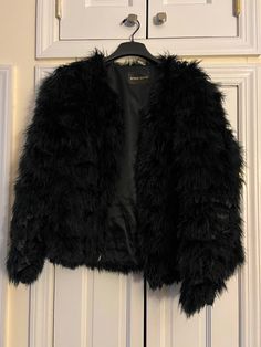 Stine Goya Bird Jacket - Black Ostrich Feather Size Medium Light weight ostrich feather jacket with hook and eye closures from Denmark based designer Stine Goya.  The hooks need to be repaired. Jacket is pre-owned. Made in China. Size: Medium.  Retail Price: $580.00 No returns. Black Fur Coat With Feather Trim Long Sleeve, Black Long Sleeve Fur Coat With Feather Trim, Chic Black Fur Coat With Feather Trim, Long Sleeve Feathered Outerwear For Fall, Long Sleeve Feather Outerwear For Fall, Black Party Outerwear With Feather Trim, Chic Long Sleeve Feathered Outerwear, Feathered Long Sleeve Party Outerwear, Ostrich Feather Jacket