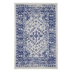 a blue and white rug with an intricate design on the bottom, in front of a white background