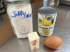 an egg, butter, and other ingredients are on the counter in front of a canister