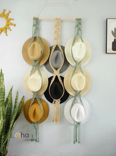 several hats hanging on a wall with one hat in the middle and two hats attached to it