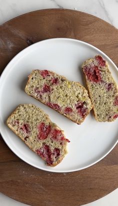 three slices of bread on a plate with raspberry toppings next to each other