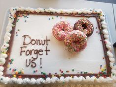 a birthday cake with two donuts on it that says, donut forget us