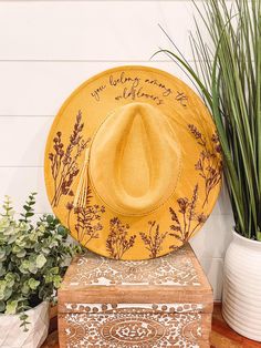 Wildflower Burned Hat, Floral Engraved Cowboy Hat, Sunflower Hat, Sunflower Burned Fedora, Engraved Suede Hat, Boho Hat, Vegan Suede Elevate your style with our beautifully engraved floral hats! Choose from a variety of different hat colors. Band may shift or fall off during shipping. The hat has an adjustable band on the inside to fit many sizes. One size fits most adult heads. If you are looking for a custom order, please message us! Bride Cowgirl Hat With Aunflowers, Cow Print Burned Hat, Adjustable Yellow Hats For Country Events, Adjustable Yellow Hat For Country Events, Bohemian Yellow Straw Hat With Short Brim, Yellow Bohemian Straw Hat With Short Brim, Yellow Bohemian Hat With Flat Brim, Yellow Bohemian Hat One Size, Yellow Bohemian Hat