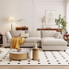 a living room with white furniture and black and white checkered rugs on the floor