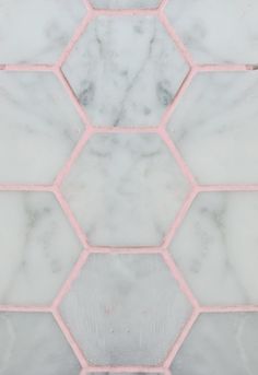 marble tiles with pink grouting in the middle and white hexagonals on each side