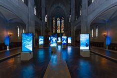 the inside of a church with multiple screens on each side and windows in the middle