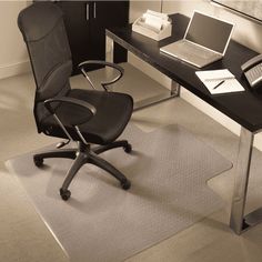 an office chair sitting on top of a carpeted floor next to a computer desk