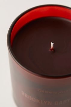 a brown candle is sitting on a white surface