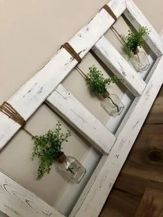 an old window is decorated with plants and mason jars for hanging on the wall or as a planter