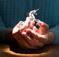 a person holding something in their hands on a table