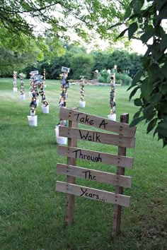 a wooden sign that says take a walk through the year with vases in it