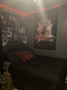 a bed room with a neatly made bed and posters on the wall