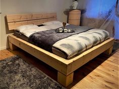 a large bed sitting on top of a wooden floor