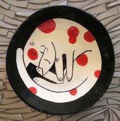 a black and white plate with red dots on it