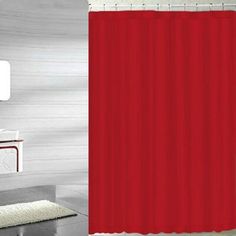 a red shower curtain in a bathroom with a rug on the floor next to it