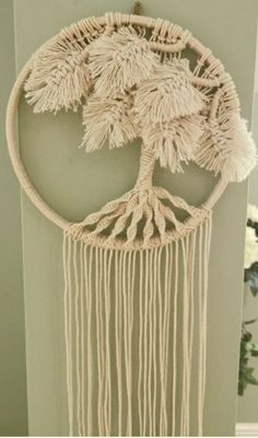 a macrame hanging on the side of a door with a tree in it