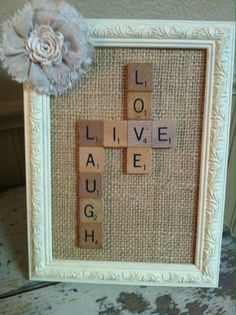 a scrabble frame with words written on it and a flower in the middle