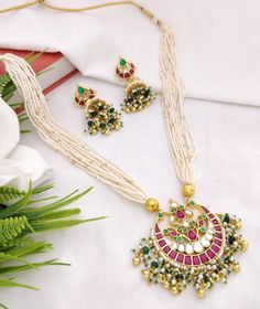 Long Sabyasachi Pacchi Kundan Necklace/ Multilayer Long Peal Necklace/ Pacchi Kundan Statement Necklace/ Bridal Kundan Necklace/ Indian Jewelry Features Traditional Pacchi Kundan Necklace set with Jhumka Earrings Made with Highest Quality Kundan Stones and Pearls Jadau work with Kundan stones and Meenakari Made in Brass with 22 Karat Gold plating Suitable for any heavy Indian/Pakistani Wedding or Party attire Perfect for all festive occasions Dimensions: Earrings: Approx. 2.5 Inches long. Earrin Celebration Chandbali Pearl Chain Necklaces, Long Kundan Necklace With Latkans For Celebration, White Necklace With Latkans For Festive Season, Festive White Necklaces With Latkans, Indian Bridal Jewelry, Ruby Bangles, Kundan Necklace Set, Party Attire, Necklace Indian