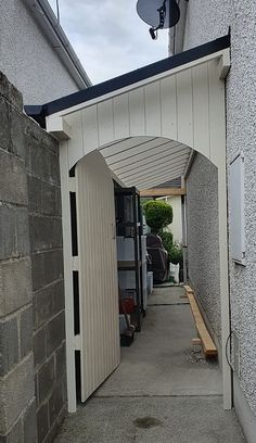 an open door leading to a building with a satellite dish on the roof