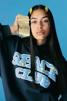 a woman with long black hair holding stacks of money