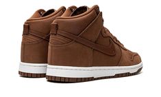 The Women’s Nike Dunk High Premium “Pecan” is a women’s-exclusive colorway of the popular sneaker with a mostly brown design.  A versatile, casual look for the Dunk High, the “Pecan” colorway features a monochromatic burnt orange upper with tonal overlays and Swoosh branding.  A debossed “Nike” logo is found on the tongue along with a classic Swoosh emblem.  Underfoot, a white rubber midsole and Pecan-colored rubber outsole finish off the look.  Release date: October 12, 2022 Urban Brown Lace-up Custom Sneakers, Brown High-top Sneakers With Speckled Midsole For Streetwear, Sporty Brown High-top Sneakers With Speckled Midsole, Brown High-top Sneakers With Speckled Midsole, Casual Brown High-top Sneakers With Boost Midsole, Brown Suede High-top Sneakers For Streetwear, Brown Suede Sneakers For Streetwear, Brown Basketball Shoes With Cushioned Footbed For Streetwear, Brown Mid-top Sneakers With Speckled Midsole