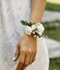 a close up of a person wearing a bracelet with flowers on it