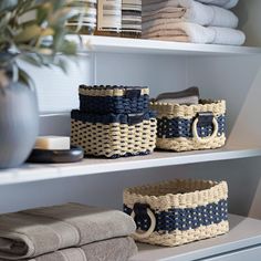 baskets and towels on shelves in a bathroom