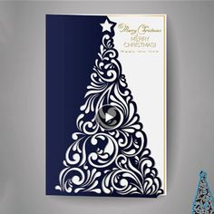 a blue and white christmas tree cut out from paper