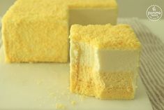 two pieces of yellow cake sitting on top of a white plate next to each other