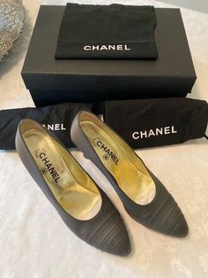 Classic Chanel Grey/Silver Satin Cap Toe Heels Shoes feature gray satin uppers and satin covered heels Cap toe has minor scuffing as seen in photo.   Gold leather insoles with CHANEL cc embossed.  Includes 2 Chanel Dust bags. Chanel Classic Heels, Heel Caps, Gold Leather, Chanel Classic, Shoes Heels, Chanel, Satin, Pumps, Grey