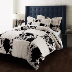 a bed with black and white comforters in a room