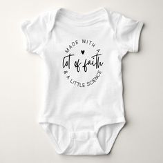 a white baby bodysuit with the words made with love written on it's chest