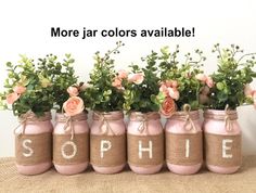 pink painted mason jars with flowers in them that spell out the word, sophiie