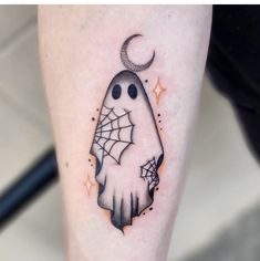 a tattoo on the leg of a person with a ghost holding a spiderweave