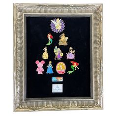 an ornate silver frame with various disney princess pins on the front and back of it