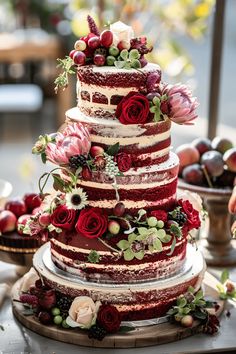 a multi layer cake with flowers and berries on top