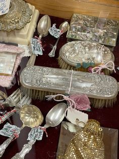 a table topped with lots of silverware and other decorative items on top of it