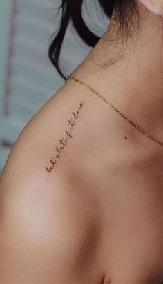 the back of a woman's shoulder with writing on it