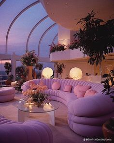 a living room filled with lots of purple furniture