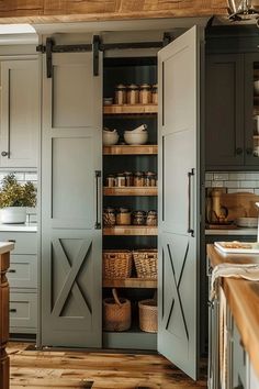 an open pantry in the middle of a kitchen with lots of cupboards and baskets